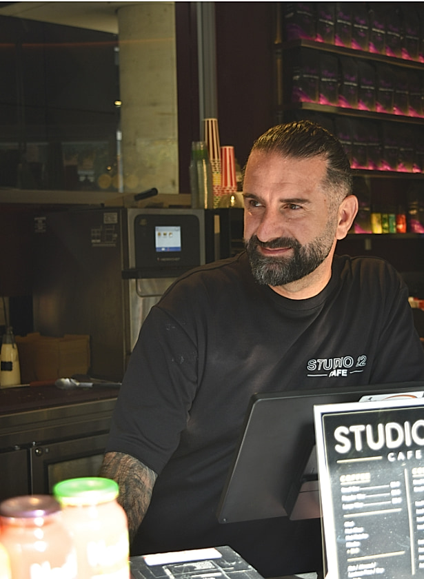 Sam, owner of Studio 22 Café, behind the register